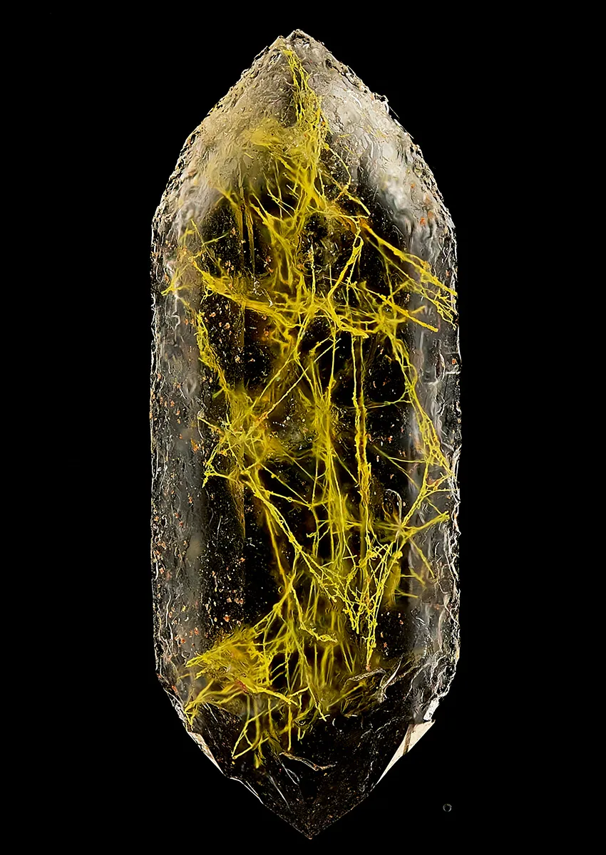 Pill shaped rock with yellow strands inside.
