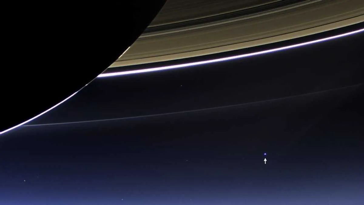 Earth (indicated by arrow) seen behind Saturn © NASA Earth (indicated by arrow) seen behind Saturn © NASA