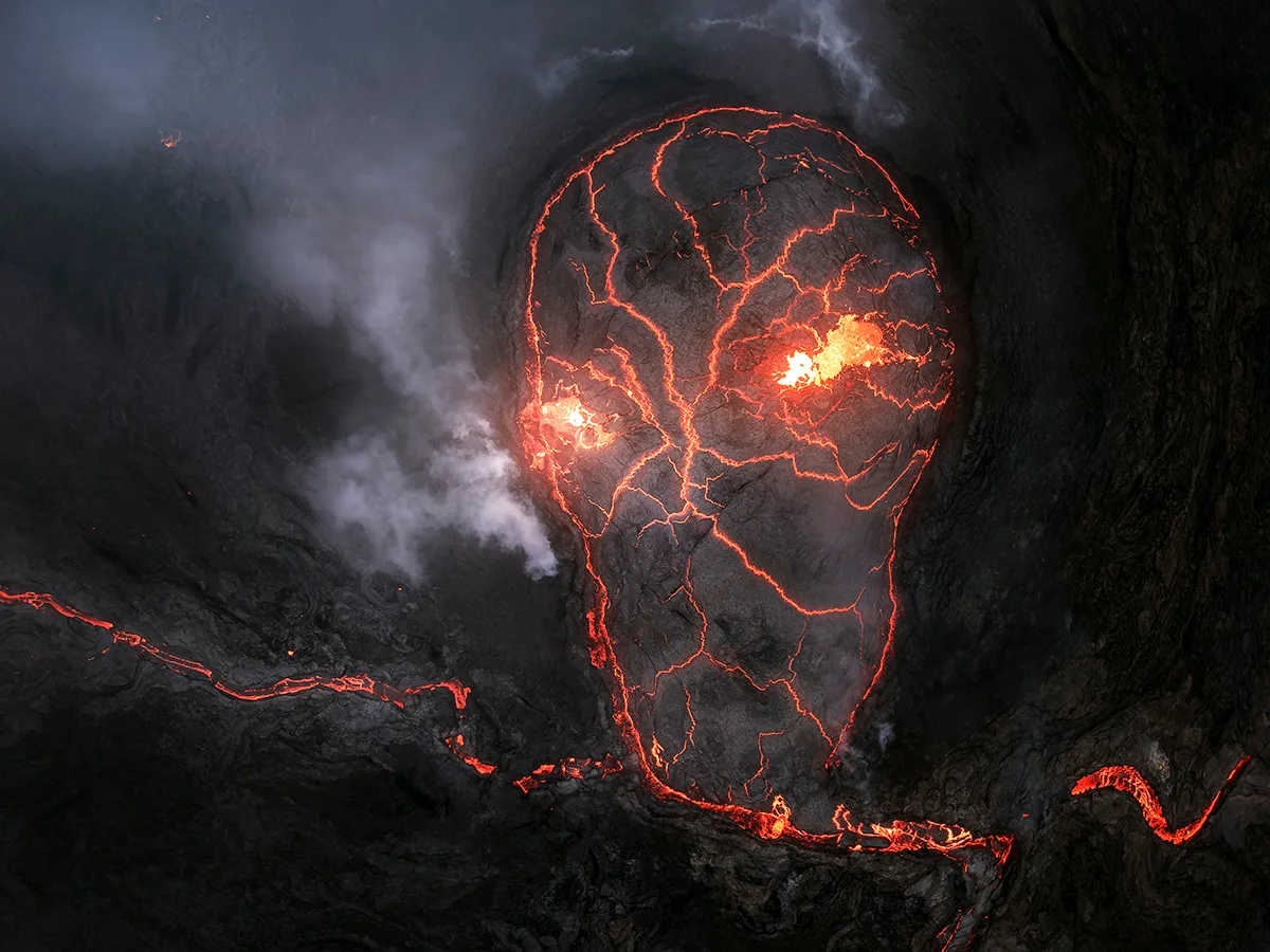 Lava trails from volcano looks like a fiery skull.