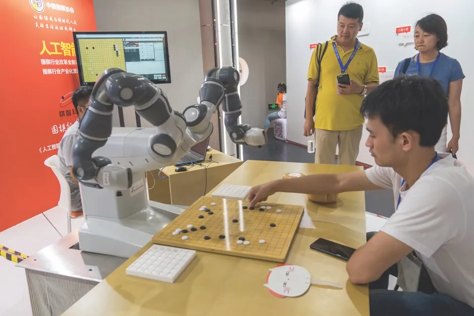 A robotic arm plays Go against a human opponent at an AI conference in Shanghai © Getty Images