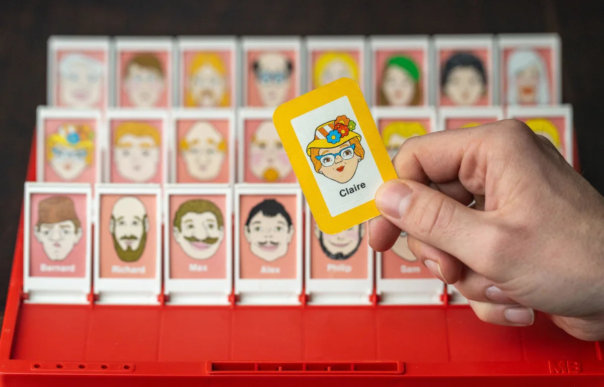 Guess Who, all the faces are up, the player is holding up the Claire card in a first-person POV