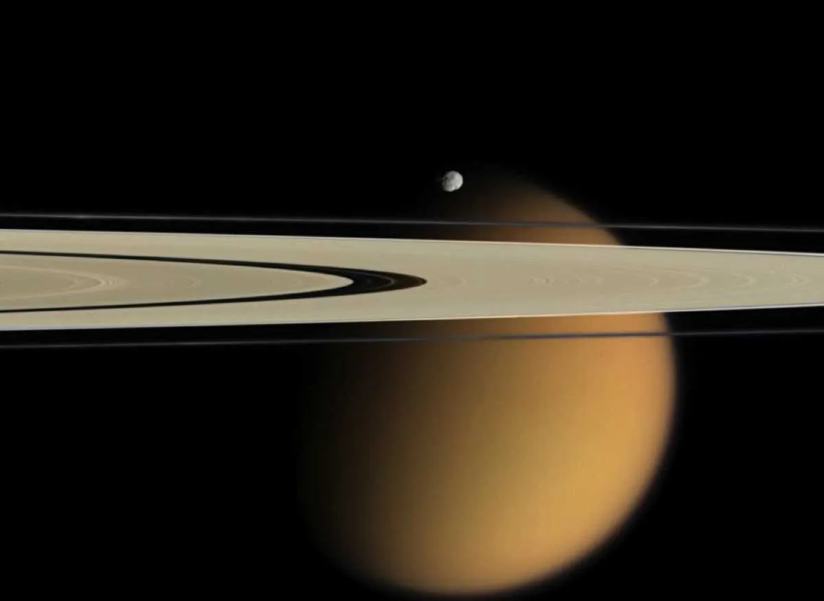 Saturn moon Epimethus with Titan in the background © NASA Saturn moon Epimethus with Titan in the background © NASA