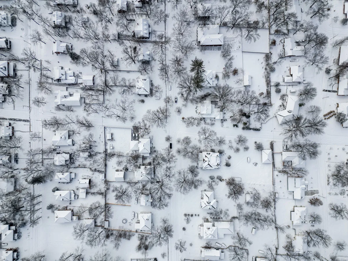An aerial photo shows several inches of fresh snow covering a residential neighborhood on January 25, 2026 in Columbia, Missouri.